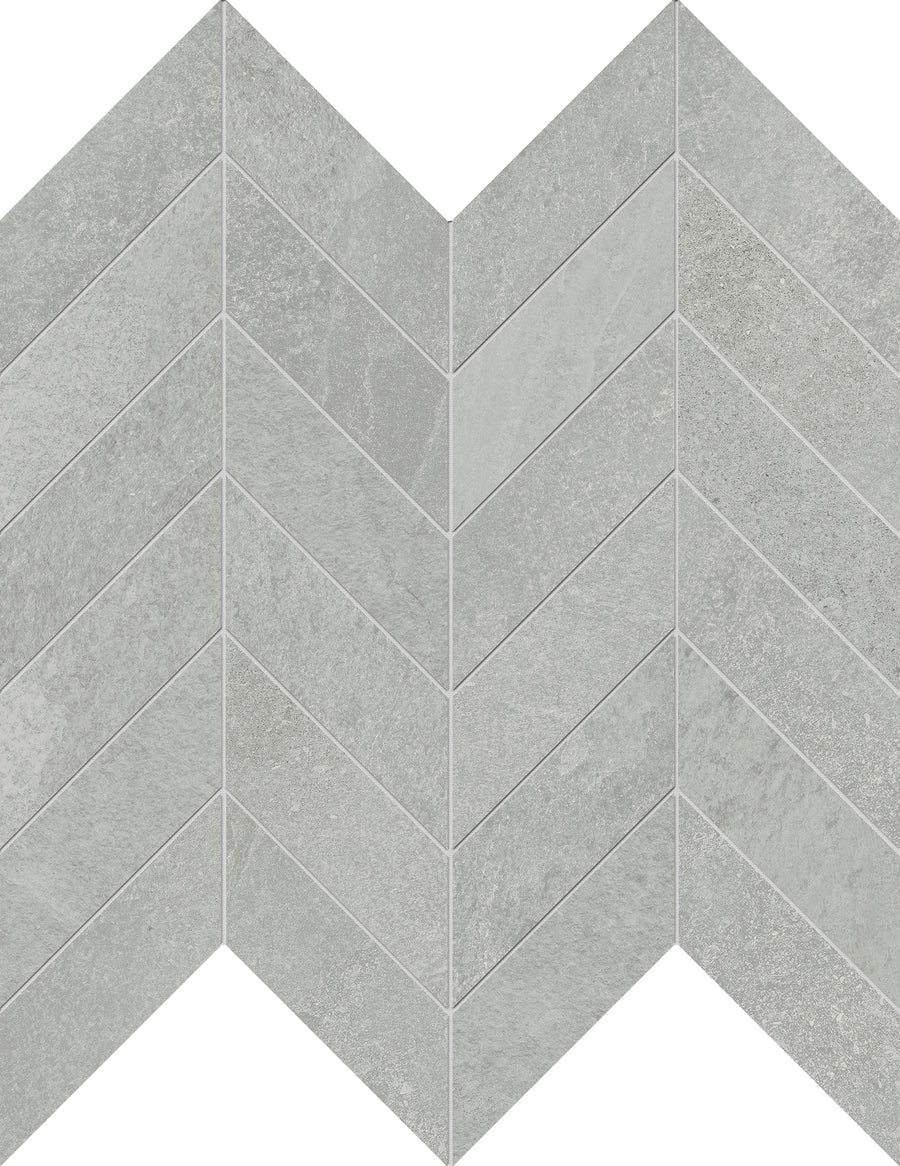 Shyft Chevron Mosaic Porcelain Tile features a light gray, zigzag pattern with a textured surface resembling stone or concrete, providing the luxurious appearance of Brazilian slate in durable porcelain.