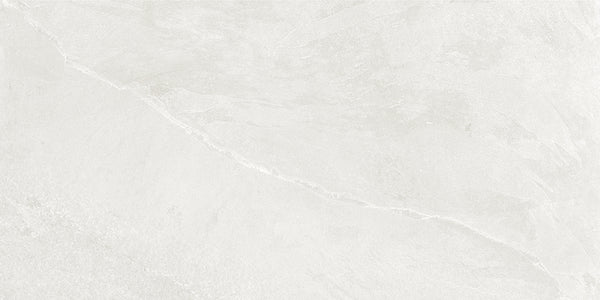 The Shyft 12x24 Rectified Porcelain Tile features a light gray base with subtle white and gray diagonal veining, resembling Brazilian slate. Its smooth, modern look makes it perfect for contemporary interiors.