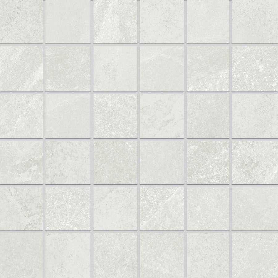 A close-up view of Shyft 2x2 Mosaic Porcelain Tile shows light gray squares with subtle texture and shading inspired by Brazilian slate, arranged in a grid and separated by thin grout lines.