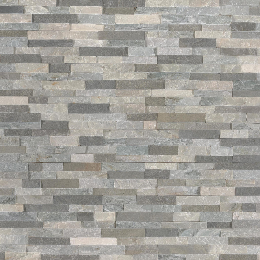 A close-up of a wall featuring Landscape 4.5x16 Natural Stone Ledger Panel tiles in grey and beige tones, arranged in a staggered pattern for a modern look.