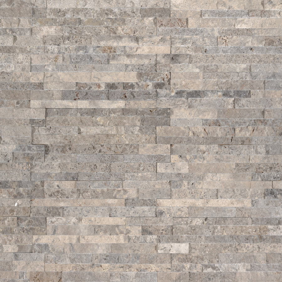A close-up of a textured wall features the Landscape 4.5x16 Natural Stone Ledger Panel, displaying gray and beige rectangular stones in a horizontal, staggered split face pattern for a modern look with added depth.