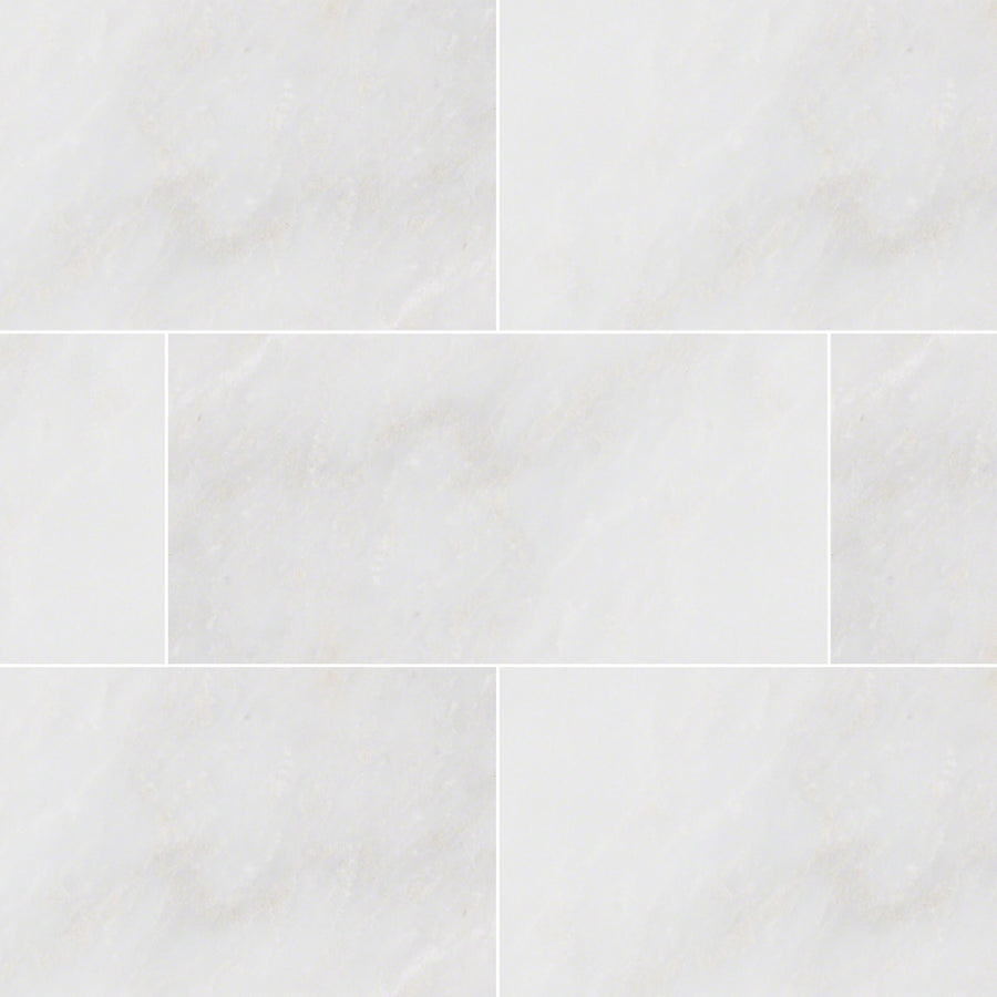 Arabescata Carrara Select 6x12 Marble tiles feature a seamless light gray and white pattern with subtle marbling and faint grout lines, offering a clean, smooth surface inspired by natural stone.