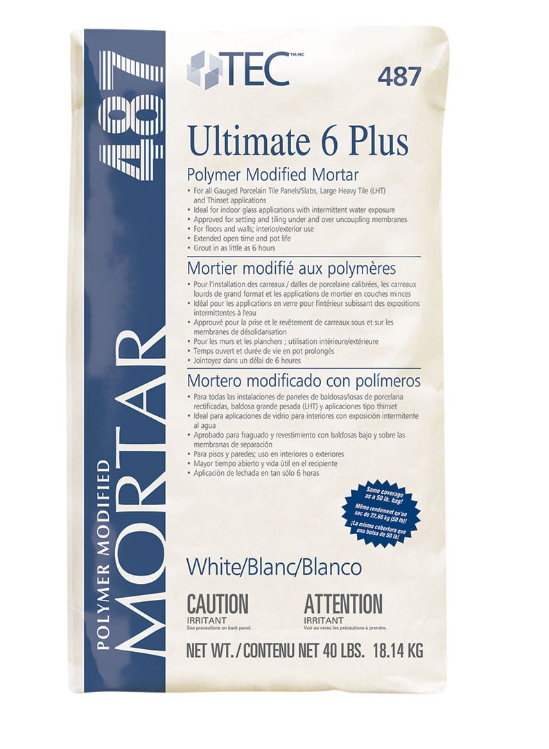 A 40 lb (18.14 kg) white bag of TEC Ultimate 6 Plus, product #487, features multilingual info on thin set applications including gauged porcelain tile panels, plus key safety warnings.