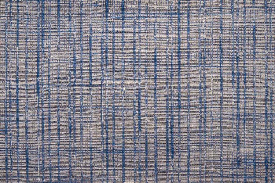 Close-up of the Texture Weave On Trend Carpet shows a blue and gray crisscross pattern with a hand-woven, grid-like look, offering artisanal appeal and modern texture.