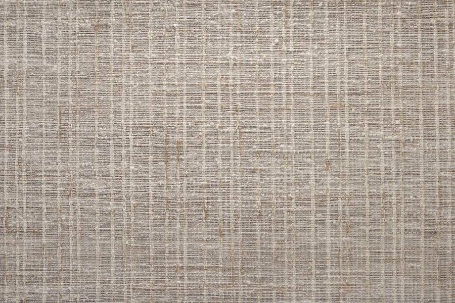 A close-up of the Texture Weave On Trend Carpet shows its hand-woven flatweave surface with a subtle crisscross pattern in neutral shades of beige and light brown, creating a stylish grid-like look.