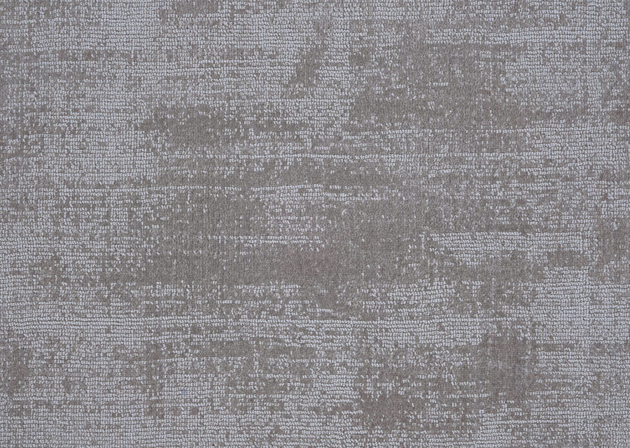 The Prague On Trend Carpet features grey textured fabric with a subtle, uneven pattern reminiscent of faint brushstrokes, creating a soft, abstract look inspired by modern color palettes.