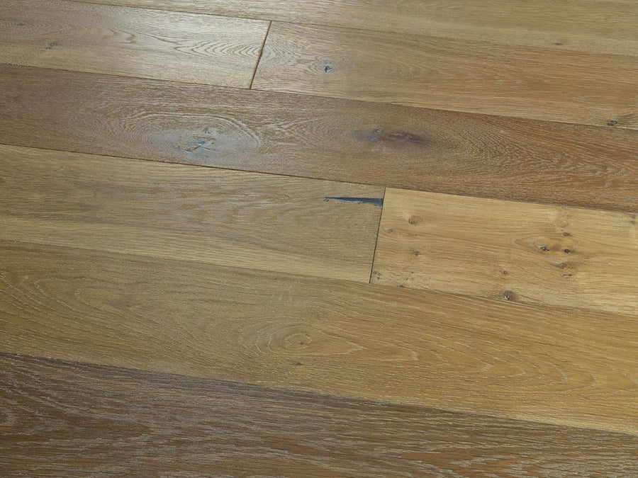 Close-up of Baldwin Hills 6" Hardwood with a natural finish, showcasing rich brown shades, distinctive grain patterns, knots, and natural imperfections that emphasize the unique character of this hardwood collection.