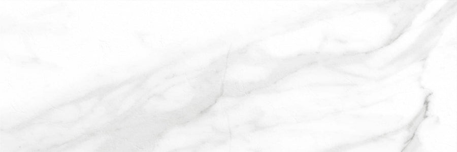 The Trevi 16x47 Rectified Porcelain Tile features a white marble-look surface with subtle grey veining, natural patterns, and a smooth polished texture—ideal for walls to create a clean, elegant space.