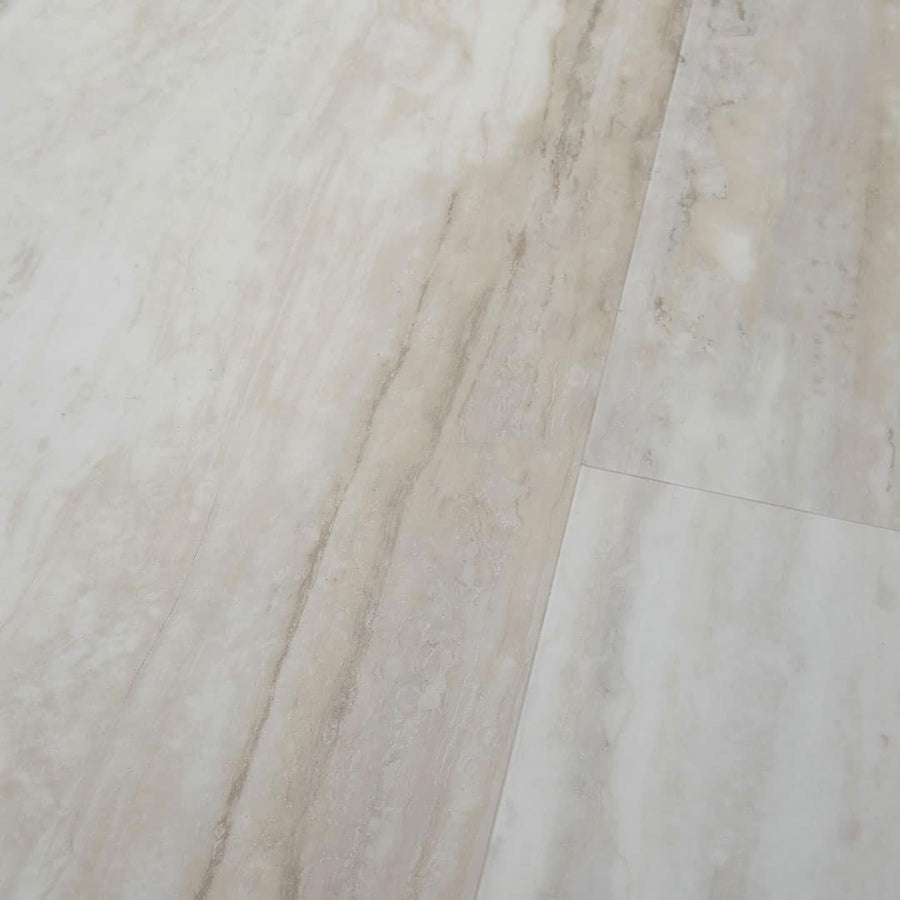 Close-up of Cascade Adura® Flex 12x24 Vinyl Tile featuring light beige and cream veining, a polished finish, and subtle color variation that mimics natural travertine.