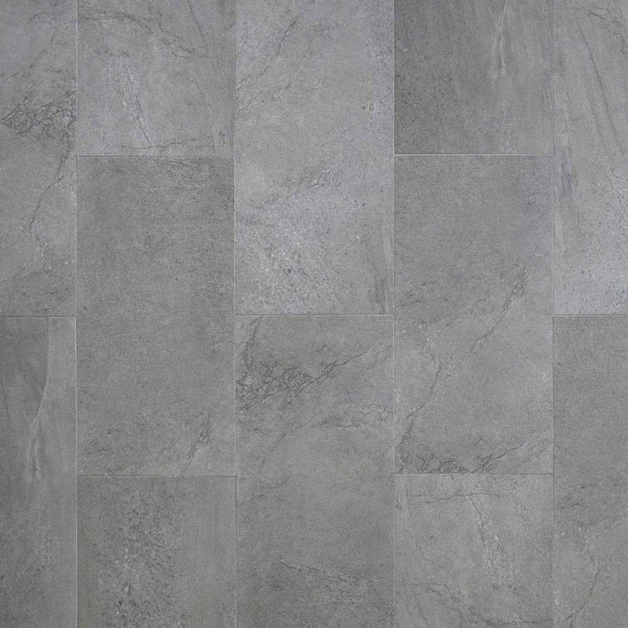 A close-up of Meridian Adura® Rigid 12x24 Vinyl Tile displays gray tiles in a staggered pattern, with subtle veining and texture for a natural, modern look similar to luxury vinyl tile and weathered concrete.