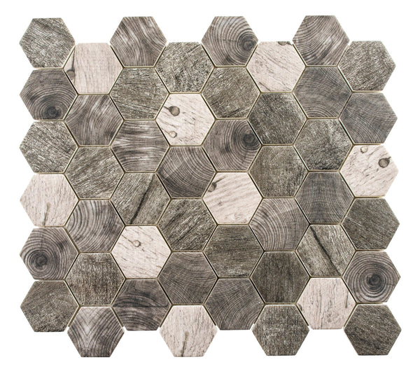 The Woodland Hexagon Mosaic Glass Tile features hexagonal pieces in gray and brown with wood grain patterns, arranged in a grid to create a textured, natural-looking wood-look mosaic surface.