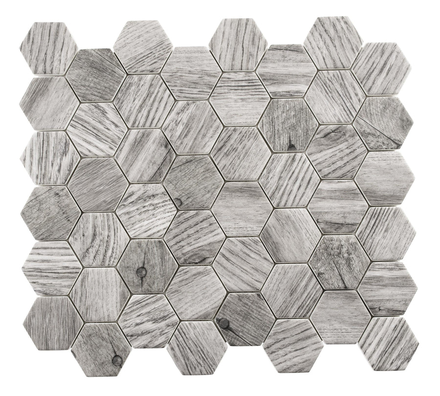Woodland Hexagon Mosaic Glass Tile features gray wood-look hexagons in a honeycomb pattern, with subtle shade and texture variations and recycled glass accents for a natural, modern geometric style.