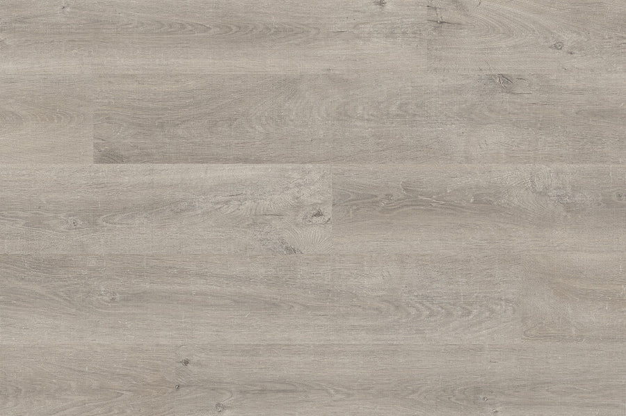 AquaPrime 6 1/8" Waterproof Laminate features light gray wood tones with subtle grain and knots, creating a smooth, modern, and minimalist look. Horizontally aligned planks offer rich texture with the timeless style of hardwood.