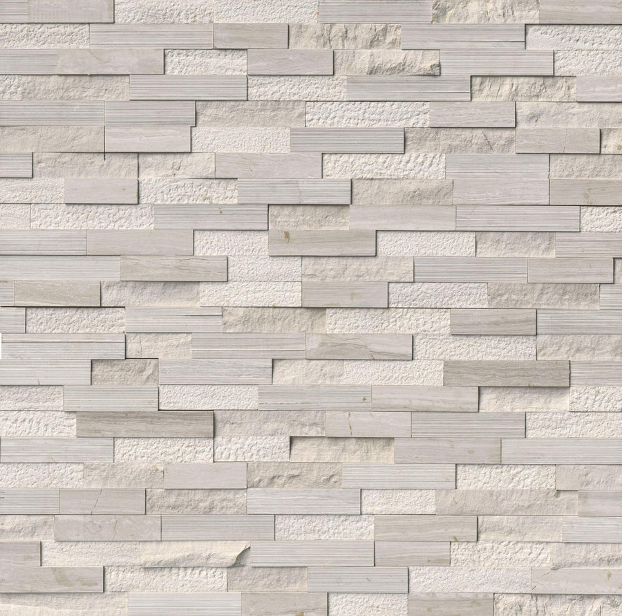 A wall clad in Landscape 6x24 Natural Stone Ledger Panel, featuring rectangular split face tiles in light gray and beige tones, arranged in a staggered pattern for a modern look.