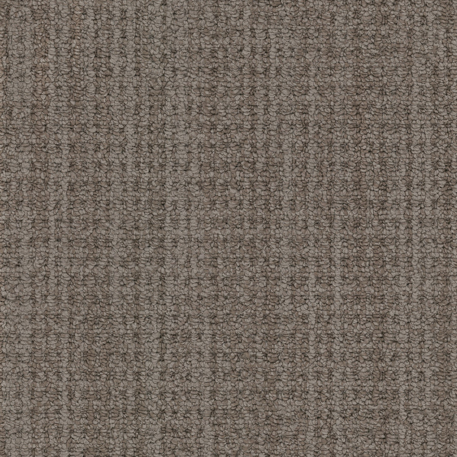 Close-up view of Winslow Berber Carpet featuring a multi-dimensional loop pattern. Tightly woven fibers create subtle striped effects in varying shades of brown and beige, evoking natural woven textures.