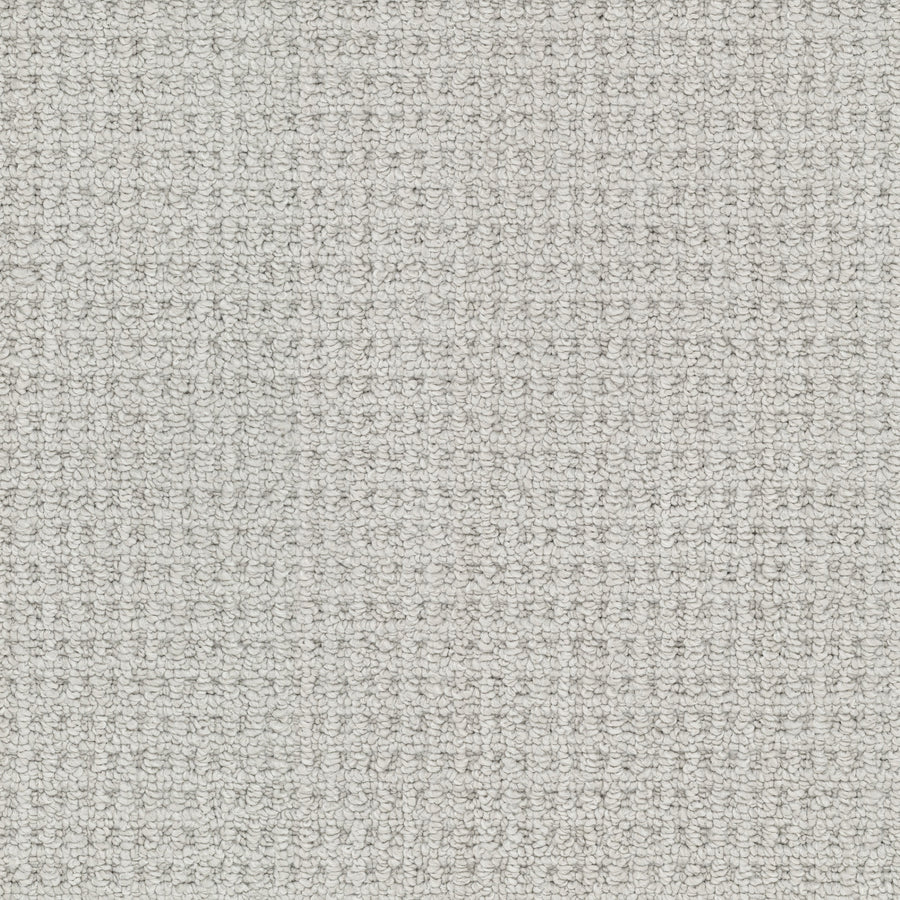 Close-up of the Winslow Berber Carpet in light gray, featuring a subtle grid pattern with fine, even threads and natural woven textures for a soft, neutral look.
