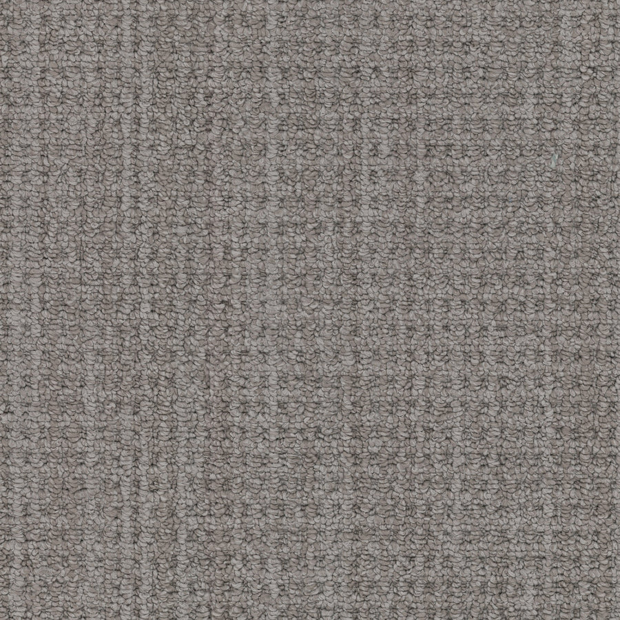 Close-up of Winslow Berber Carpet featuring a gray, woven texture and tight, multi-dimensional loop pattern. The durable and uniform material is ideal for upholstery or carpeting.