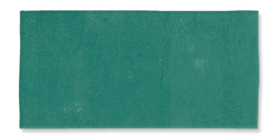 The Fez 2.5x5 Subway Tile is a rectangular, teal glazed ceramic tile with a slightly textured surface and subtle color variations, evoking classic subway tile style.