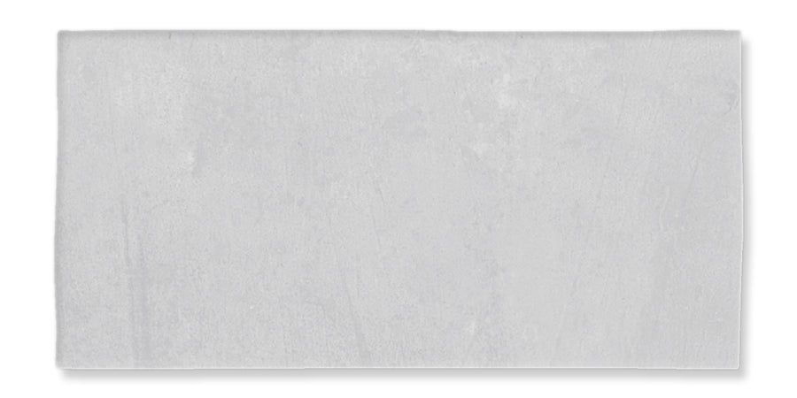 The Fez 2.5x5 Subway Tile is a rectangular, light gray glazed ceramic tile with a smooth surface, shown against a white background.