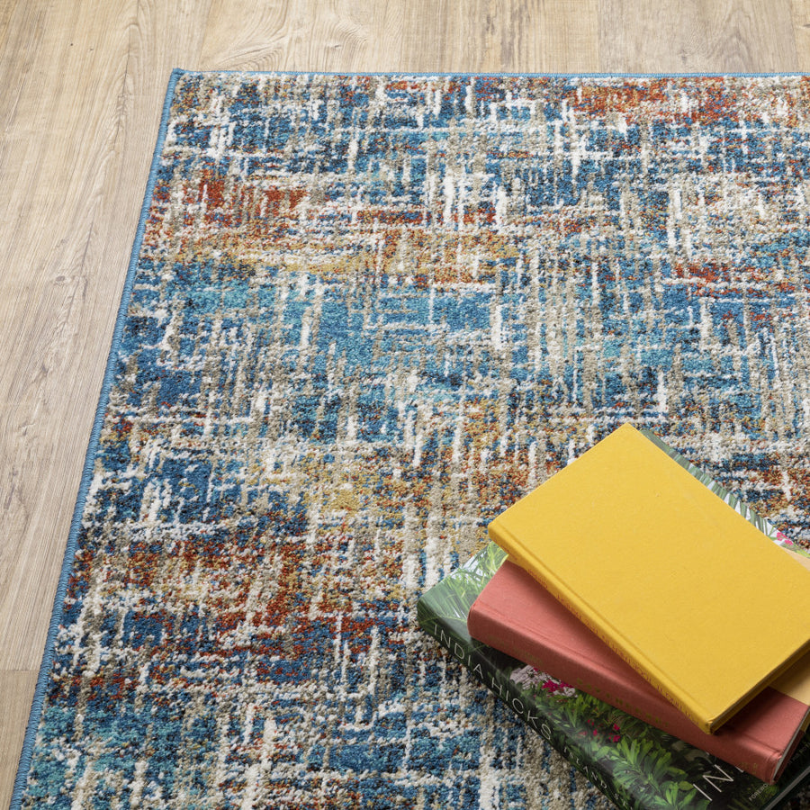 A pile of books rests on the Venice 5573X Area Rug.