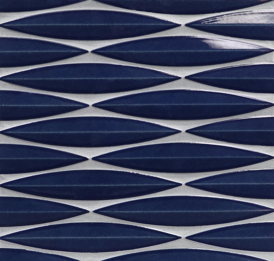 The Ka-Nu Keel 3D Mosaic Tile features rows of elongated, navy blue, leaf-shaped ceramic tiles arranged horizontally with white grout, creating a modern geometric pattern and highlighting its elegant glaze.