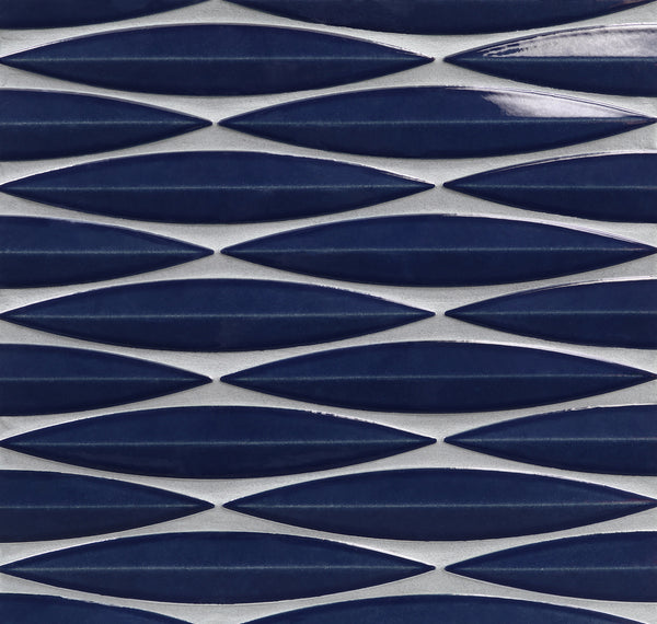 The Ka-Nu Keel 3D Mosaic Tile features rows of elongated, navy blue, leaf-shaped ceramic tiles arranged horizontally with white grout, creating a modern geometric pattern and highlighting its elegant glaze.