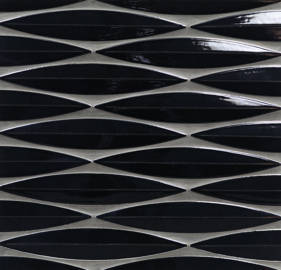 A close-up of Ka-Nu Keel 3D Mosaic Tile, showing elongated glossy black diamond-shaped ceramic tiles arranged in horizontal rows with thin metallic silver borders.