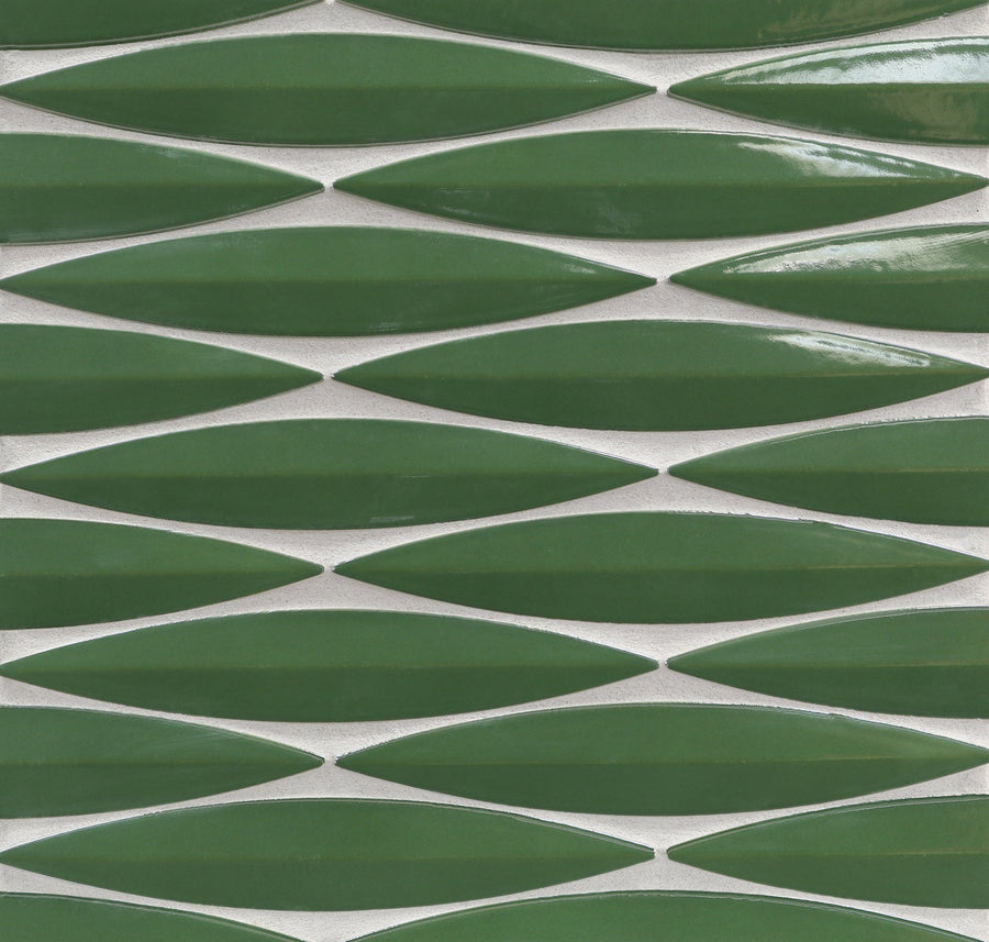 The Ka-Nu Keel 3D Mosaic Tile features glossy, green, leaf-shaped ceramic pieces in a repeating geometric pattern, highlighted by brilliant glaze colors and white grout.