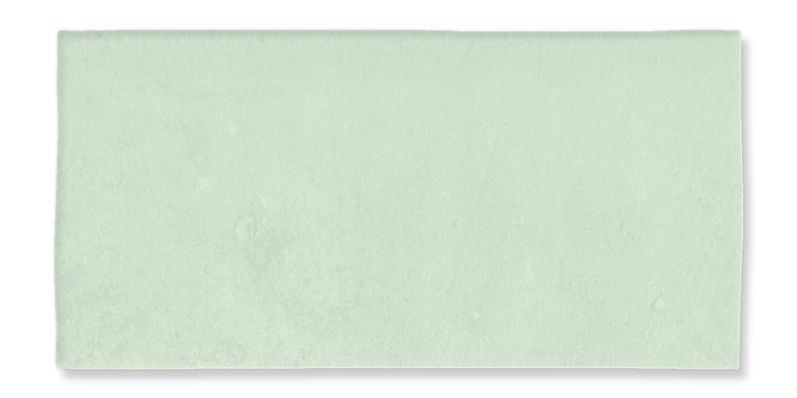 The Fez 2.5x5 Subway Tile is a rectangular, pale green ceramic tile with a matte glaze and subtly uneven surface, evoking traditional Zellige craftsmanship.