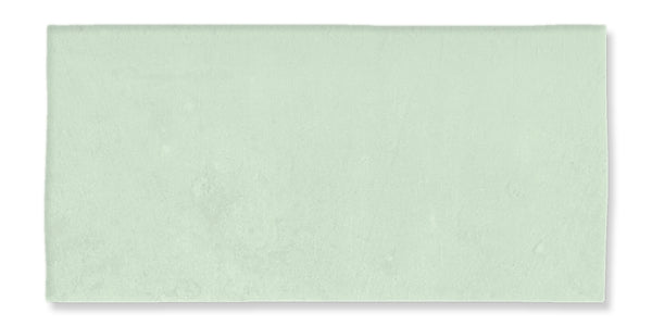 The Fez 2.5x5 Subway Tile is a rectangular, pale green ceramic tile with a matte glaze and subtly uneven surface, evoking traditional Zellige craftsmanship.