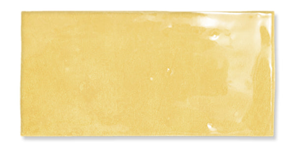 The Fez 2.5x5 Subway Tile is a rectangular, glossy yellow glazed ceramic tile with a smooth, shiny surface and subtle variations in texture and color.
