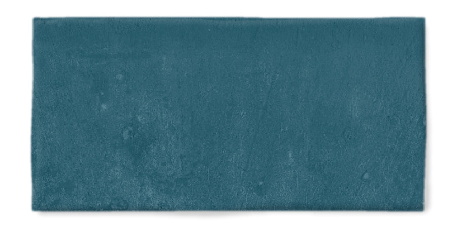 The Fez 2.5x5 Subway Tile is a rectangular glazed ceramic tile in a solid teal blue with a lightly textured matte finish.