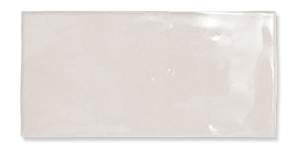 Fez 2.5x5 Subway Tile: a rectangular, light beige glazed ceramic tile with a glossy, smooth yet slightly uneven surface and subtle reflections.